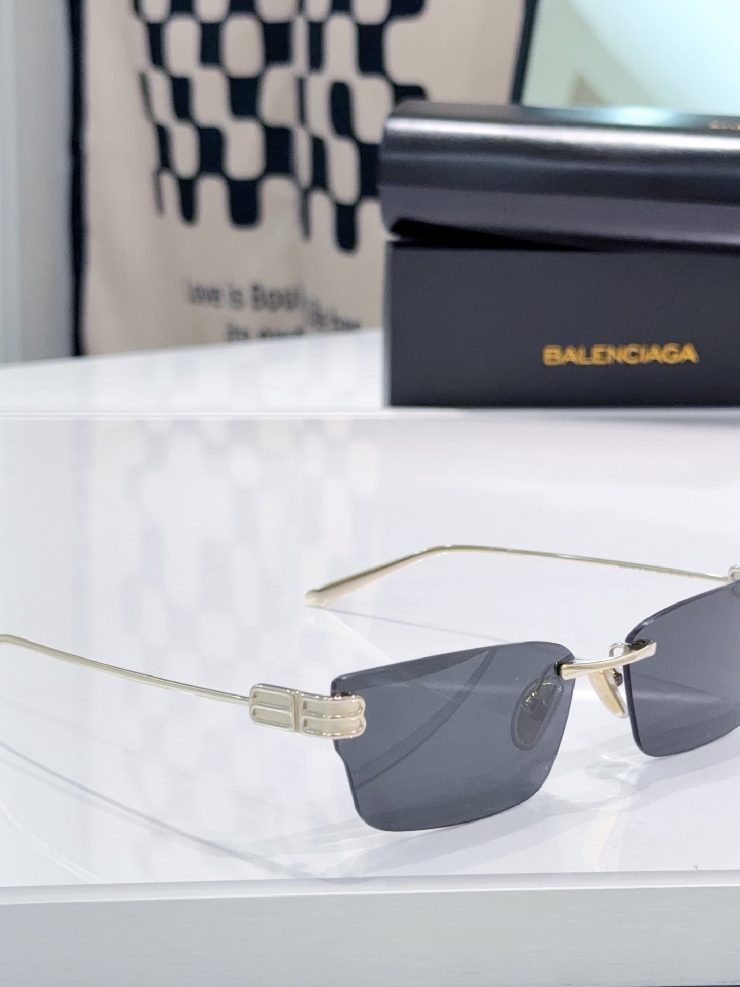Gold-tone sunglasses with dark lenses and wide metal bridge clasp