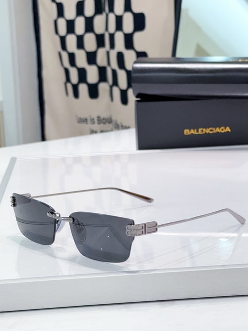 Gold-tone rectangular sunglasses with dark gray lenses and metal bridge detail