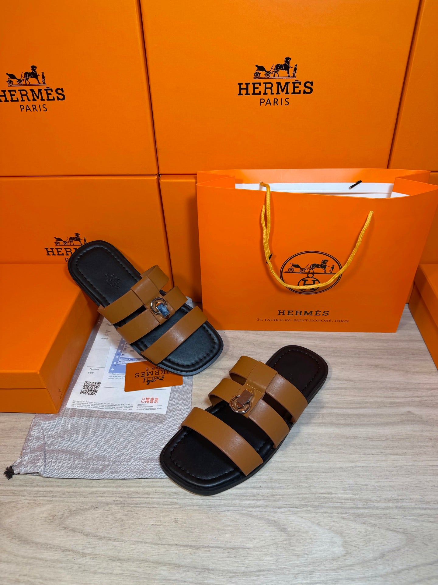 Hermes leather sandals with tan straps and silver buckle, dark sole and footbed.