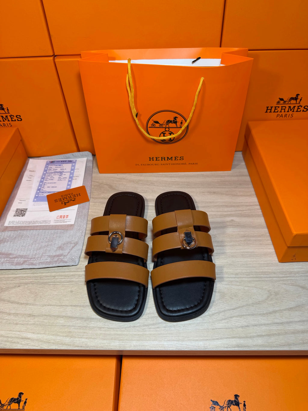 Hermes leather sandals with tan straps and silver buckle, dark footbed.