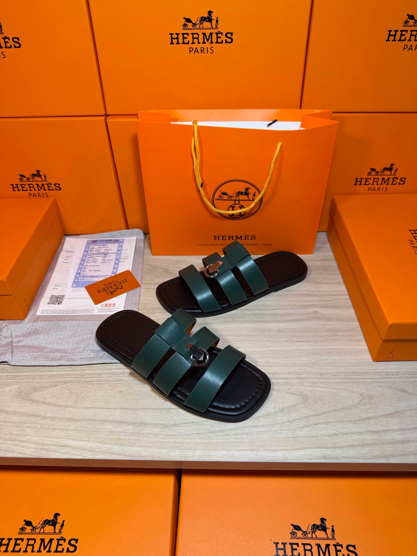 Hermes green leather slide sandals with two wide straps and silver buckle detail