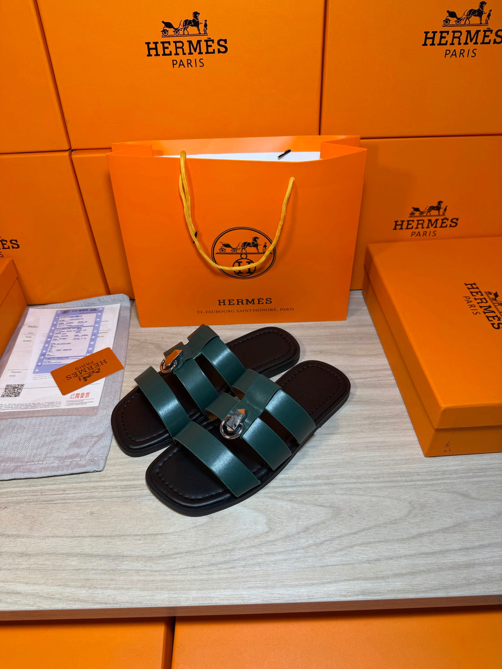Hermes green leather slide sandals with two wide straps and silver buckle hardware