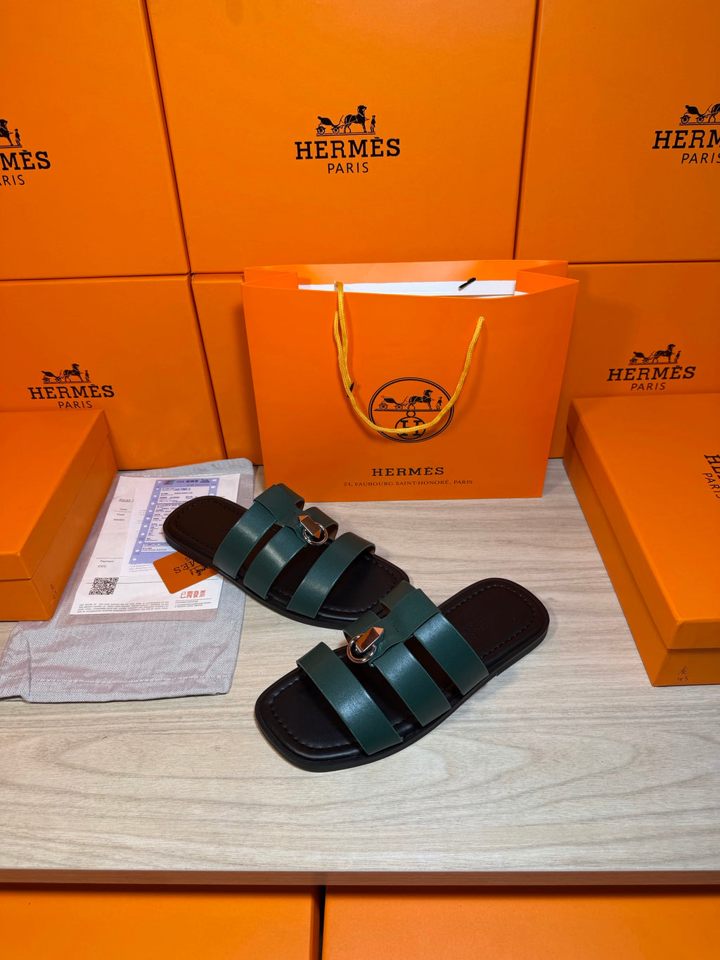 Hermes green leather slide sandals with two wide straps and round silver buckle