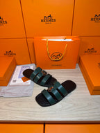 Hermes green leather slide sandals with two wide straps and round silver buckle