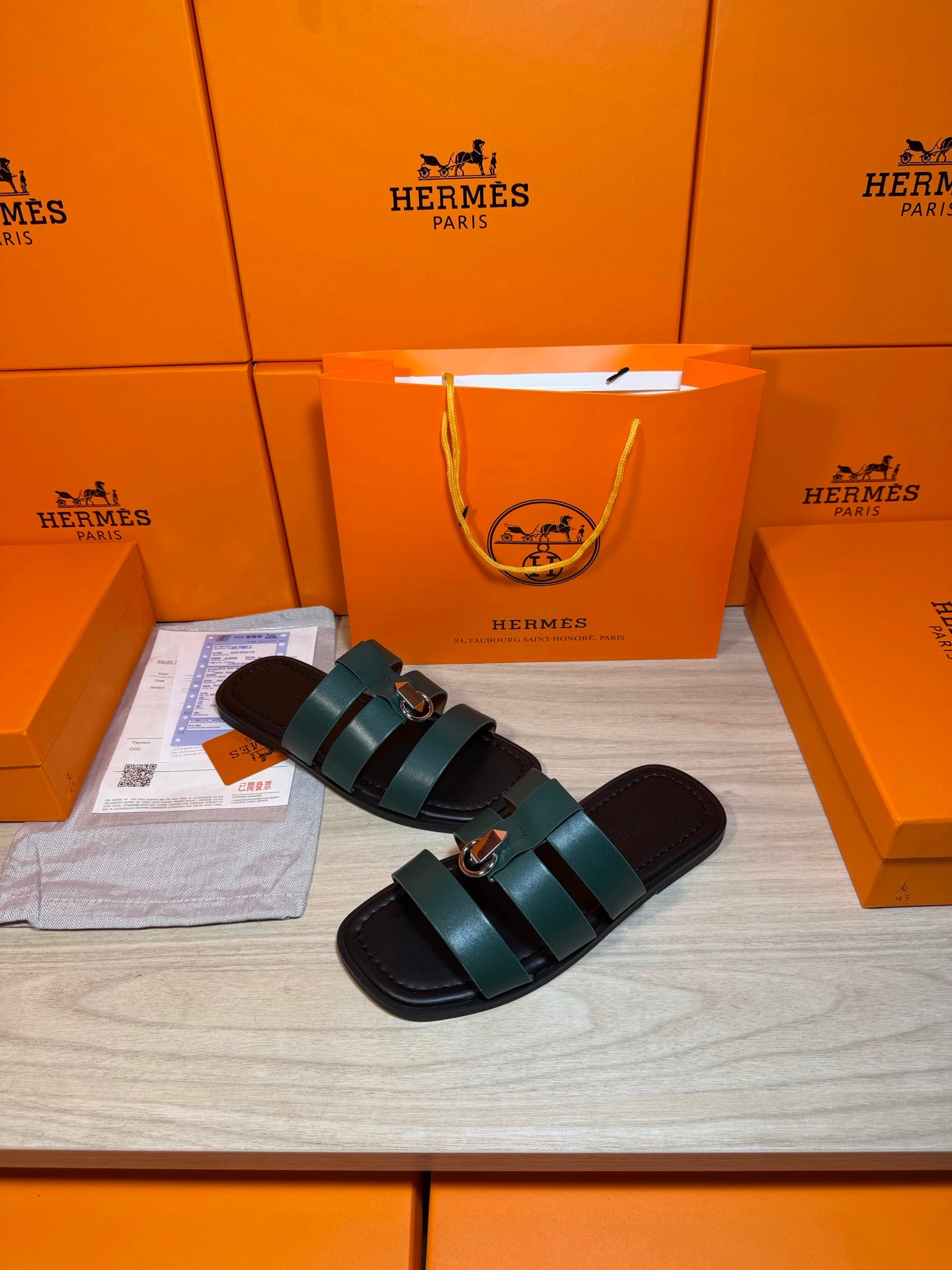 Hermes green leather slide sandals with two wide straps and round silver buckle