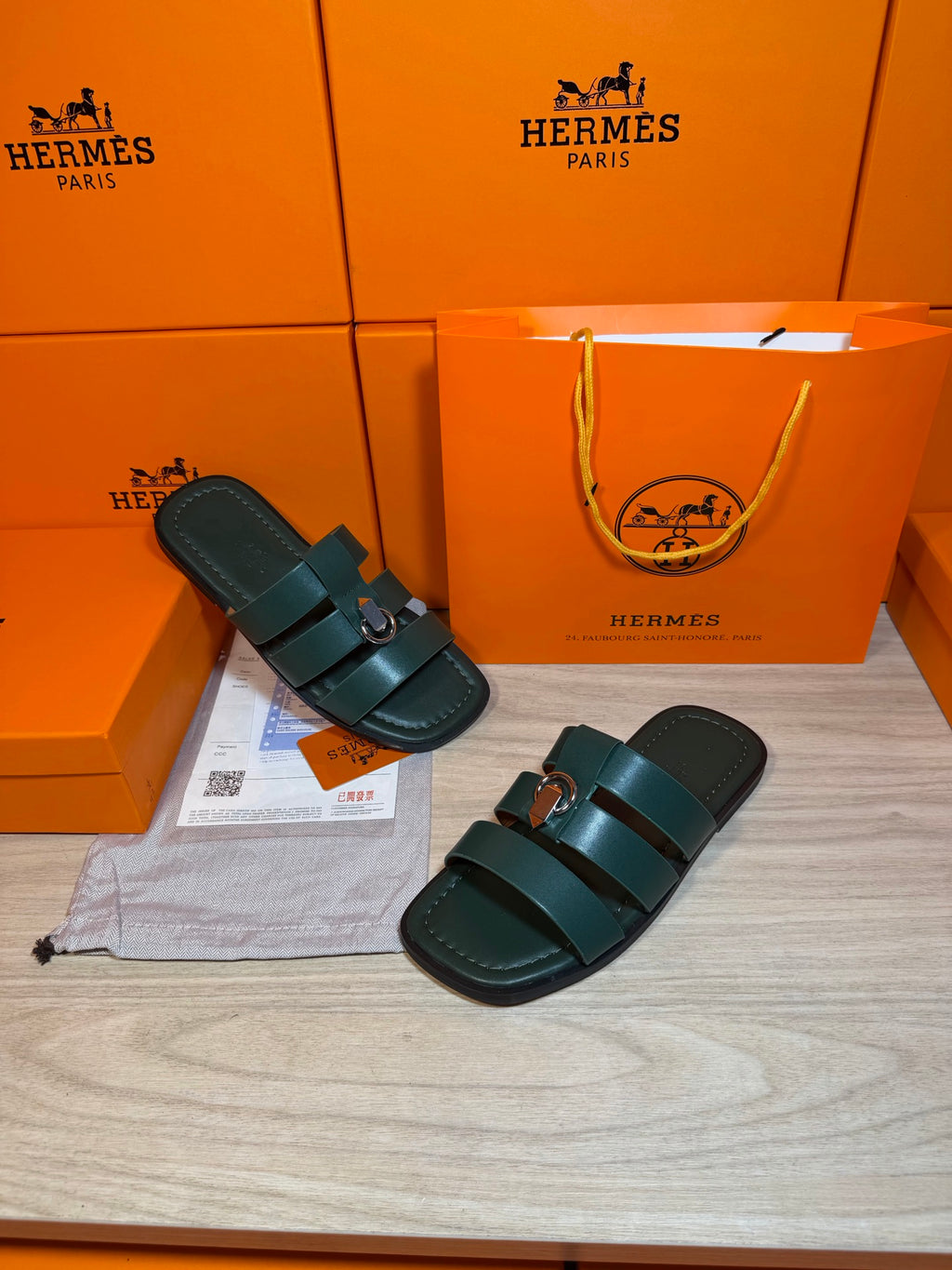 Teal leather slide sandals with two straps and silver buckle, pair on display
