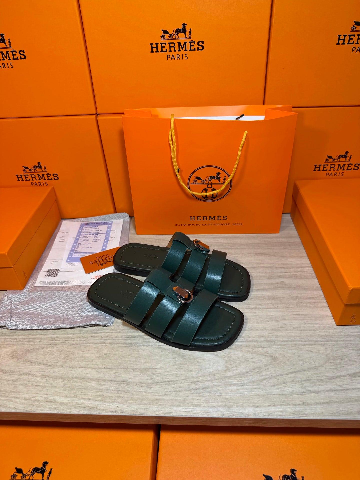 Teal leather slide sandals with two straps and silver buckle on flat footbed