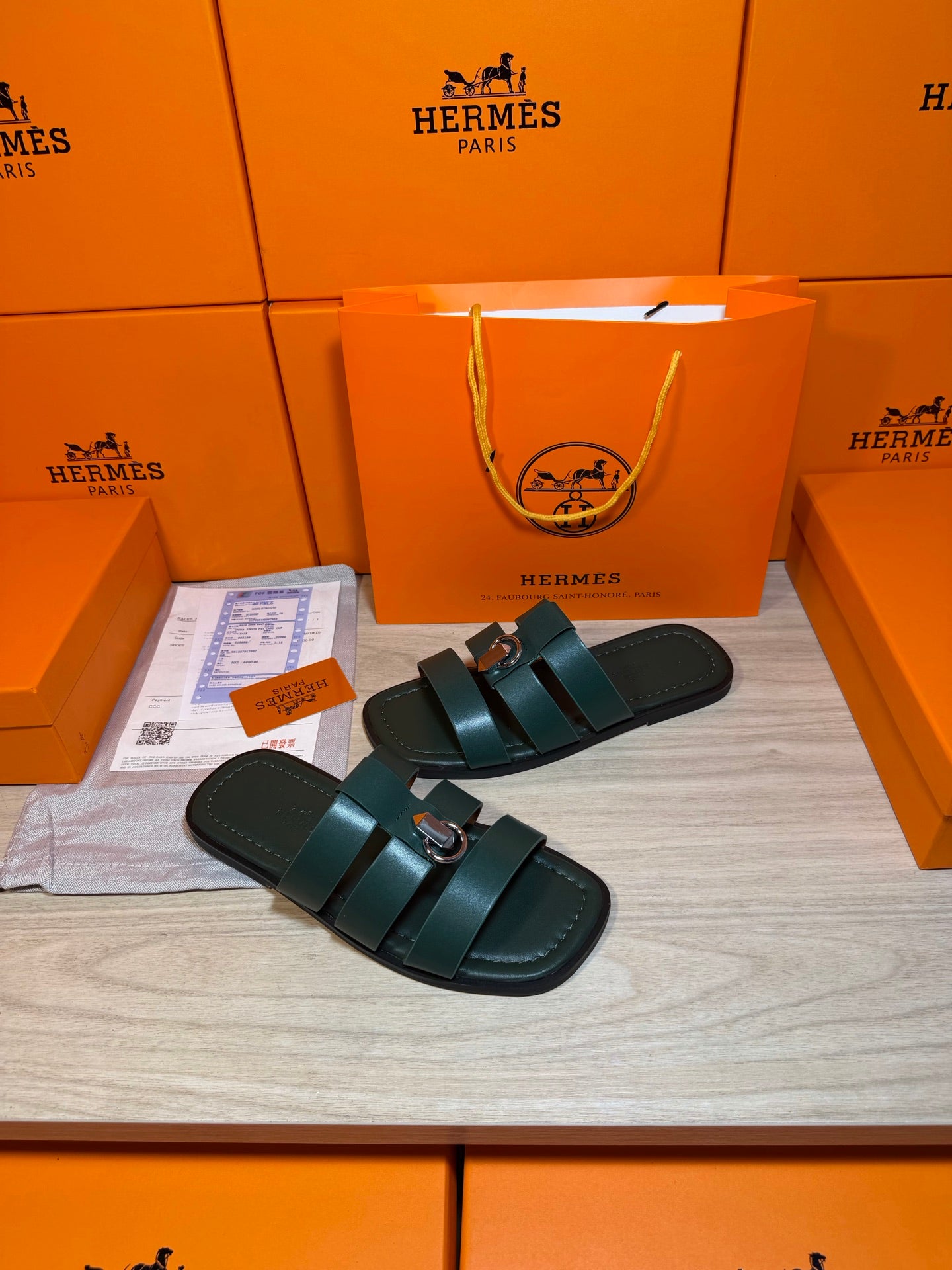 Teal leather slide sandals featuring two wide straps and silver buckle, flat sole