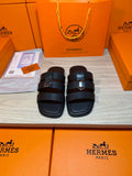 Hermes leather slide sandals with two dark wide straps and metal buckle detail