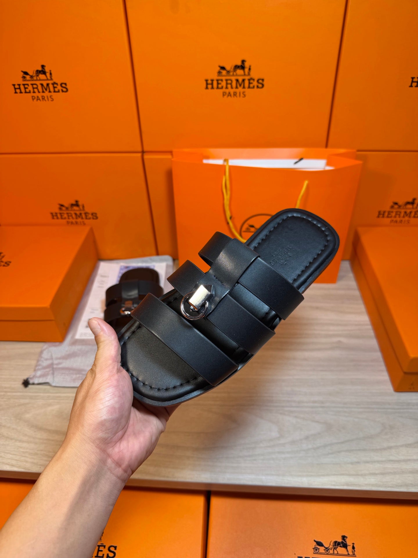 Held dark leather slide sandal with two wide straps and round metal buckle on top