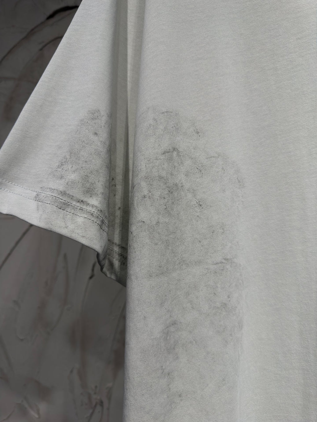 Balenciaga T-shirt, light gray fabric close-up with stitched hem and sleeve