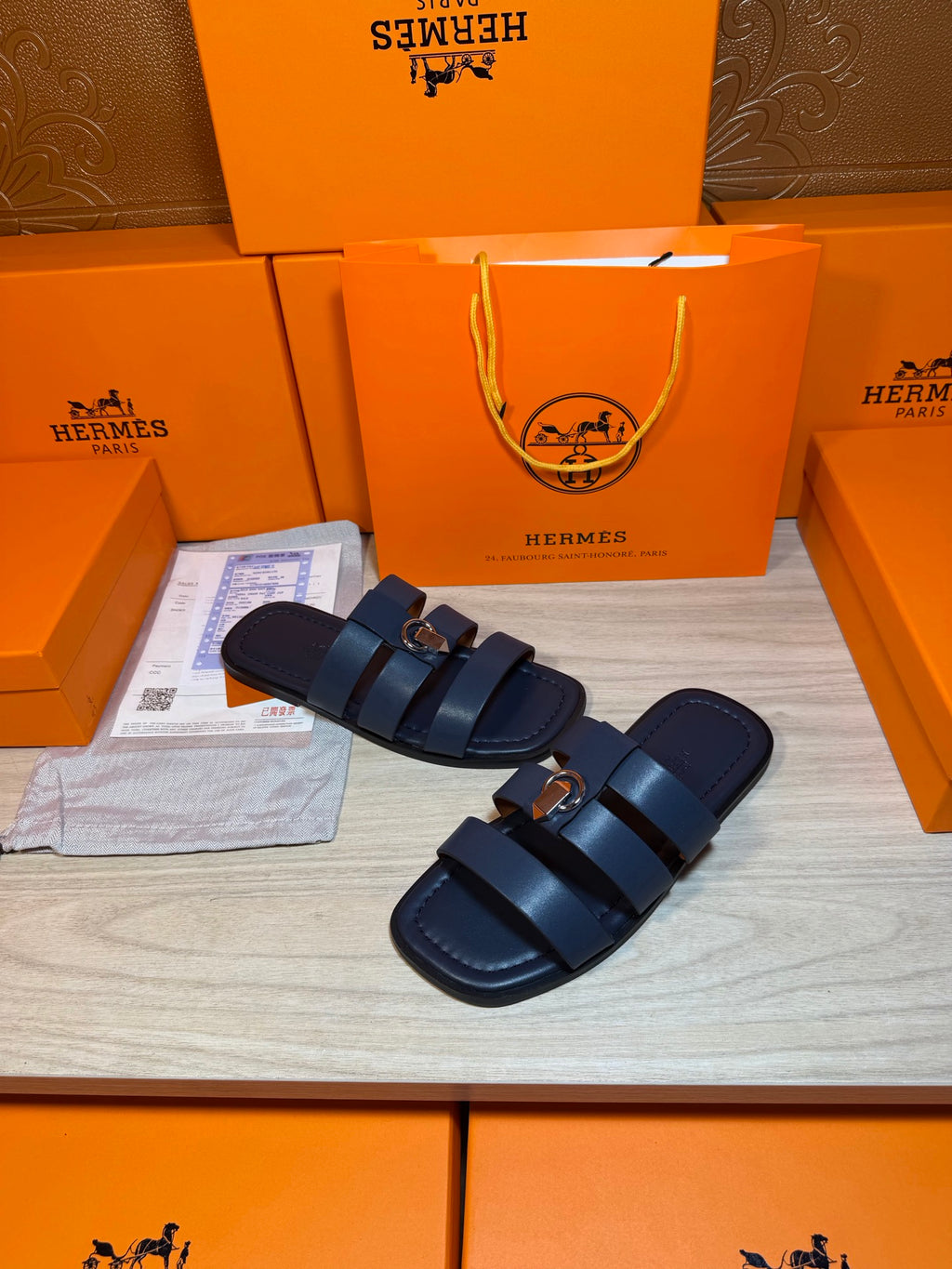 Dark blue leather slide sandals with double cross straps and silver metal buckle