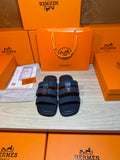 Dark blue leather slide sandals with two adjustable straps and metal buckle