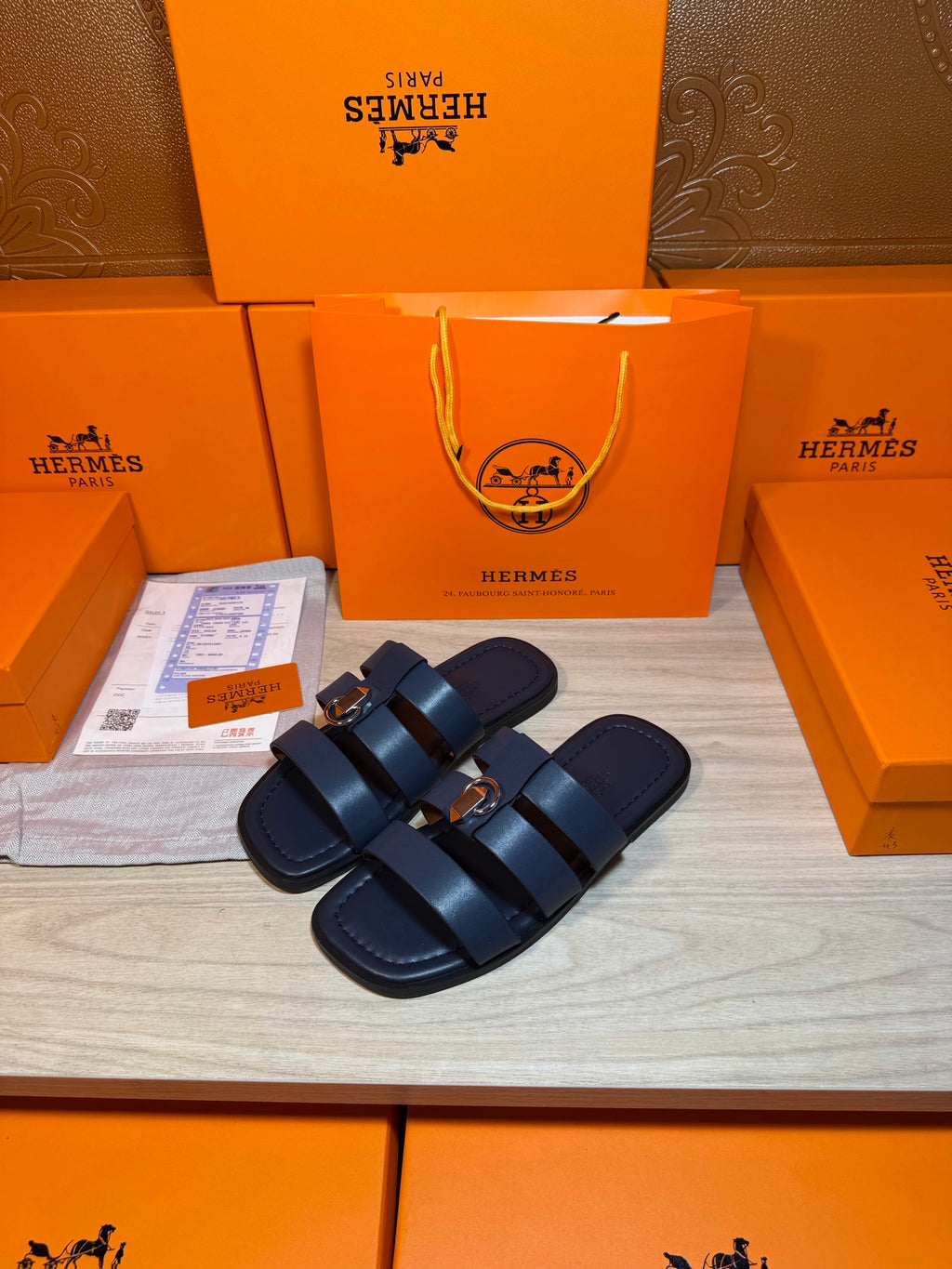 Dark blue slide sandals with two wide straps and round metal buckles