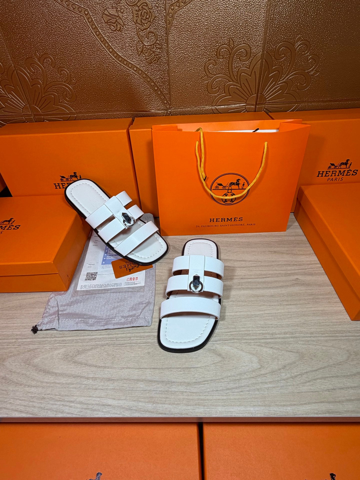 Hermes white leather slide sandals, close side view with double straps and silver buckle