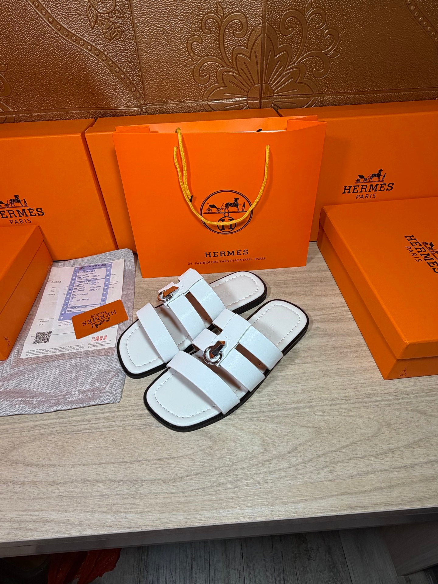 Hermes white leather slide sandals, side view with metal buckle and double straps