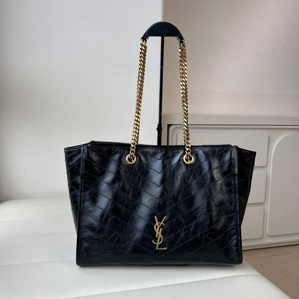 YSL quilted leather tote bag with gold chain handles and front YSL logo