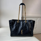 YSL quilted leather tote bag with gold chain handles and front YSL logo