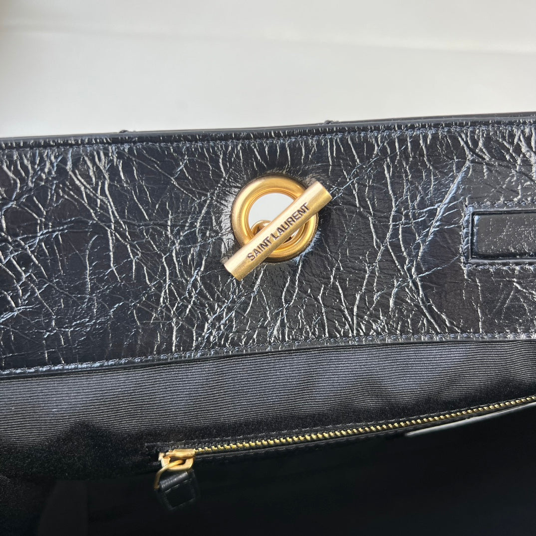 YSL quilted leather bag with gold logo ring and top zipper hardware