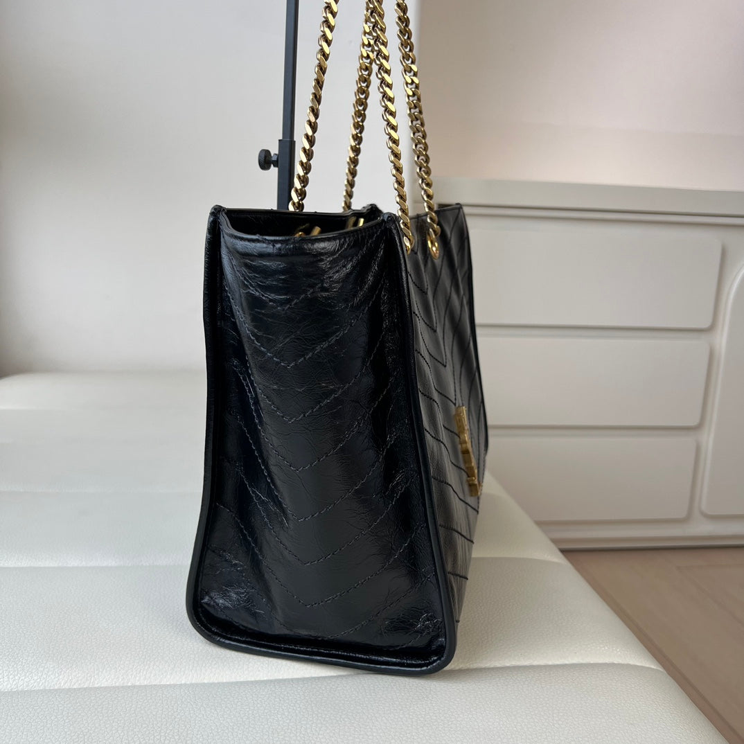 YSL quilted leather bag with gold chain straps and YSL logo on side