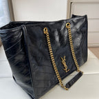 YSL quilted leather tote bag with gold chain straps, YSL logo, and side tassel
