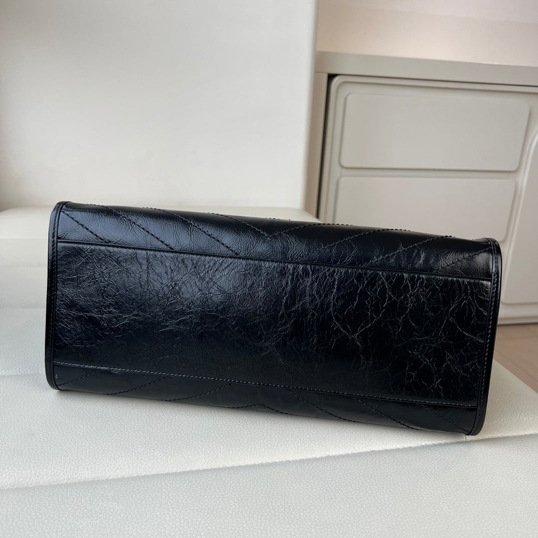 YSL black quilted leather clutch bag with gold logo hardware