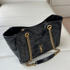 Black leather tote bag with gold chain strap and YSL logo on front panel