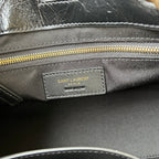 Black fabric-lined tote interior with SAINT LAURENT PARIS label and gold zipper