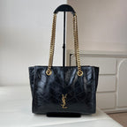 Black quilted leather tote bag with gold YSL emblem and chain shoulder handles