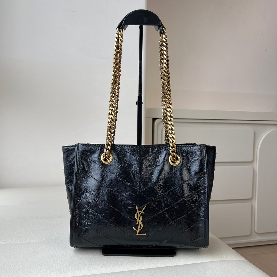 Black quilted leather tote bag with gold YSL emblem and chain shoulder handles