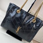 Black quilted leather tote bag with gold YSL logo and ring-top chain handles