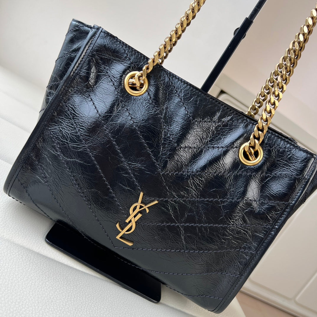 Black quilted leather tote bag with gold YSL logo and ring-top chain handles