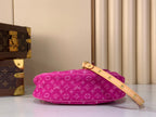 Louis Vuitton fuchsia monogram shoulder bag with thin crossbody strap and gold buckle accents