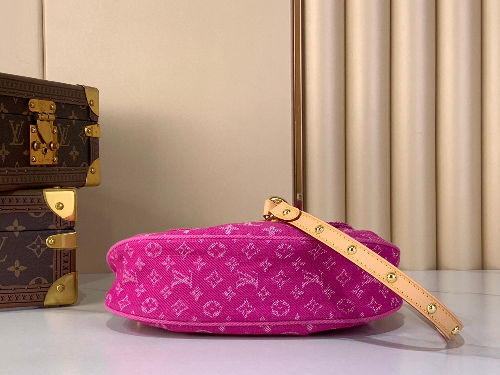 Louis Vuitton fuchsia monogram shoulder bag with thin crossbody strap and gold buckle accents