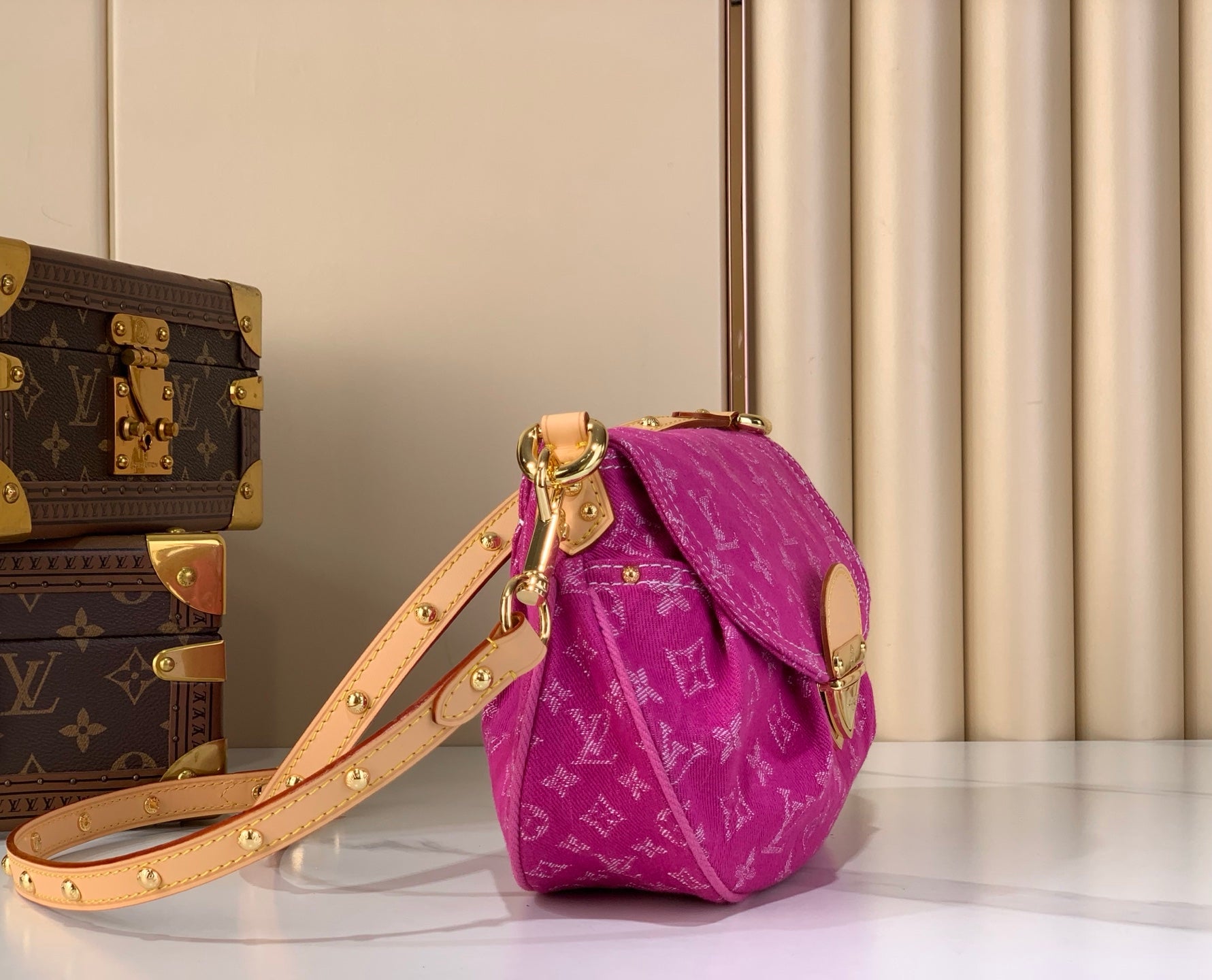 Louis Vuitton fuchsia monogram shoulder bag with gold strap hardware and flap closure
