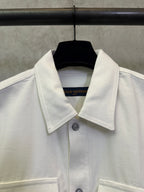 White button-up jacket collar with visible buttons and front panel
