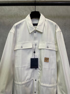 White long-sleeve button-up jacket with chest pockets and button placket
