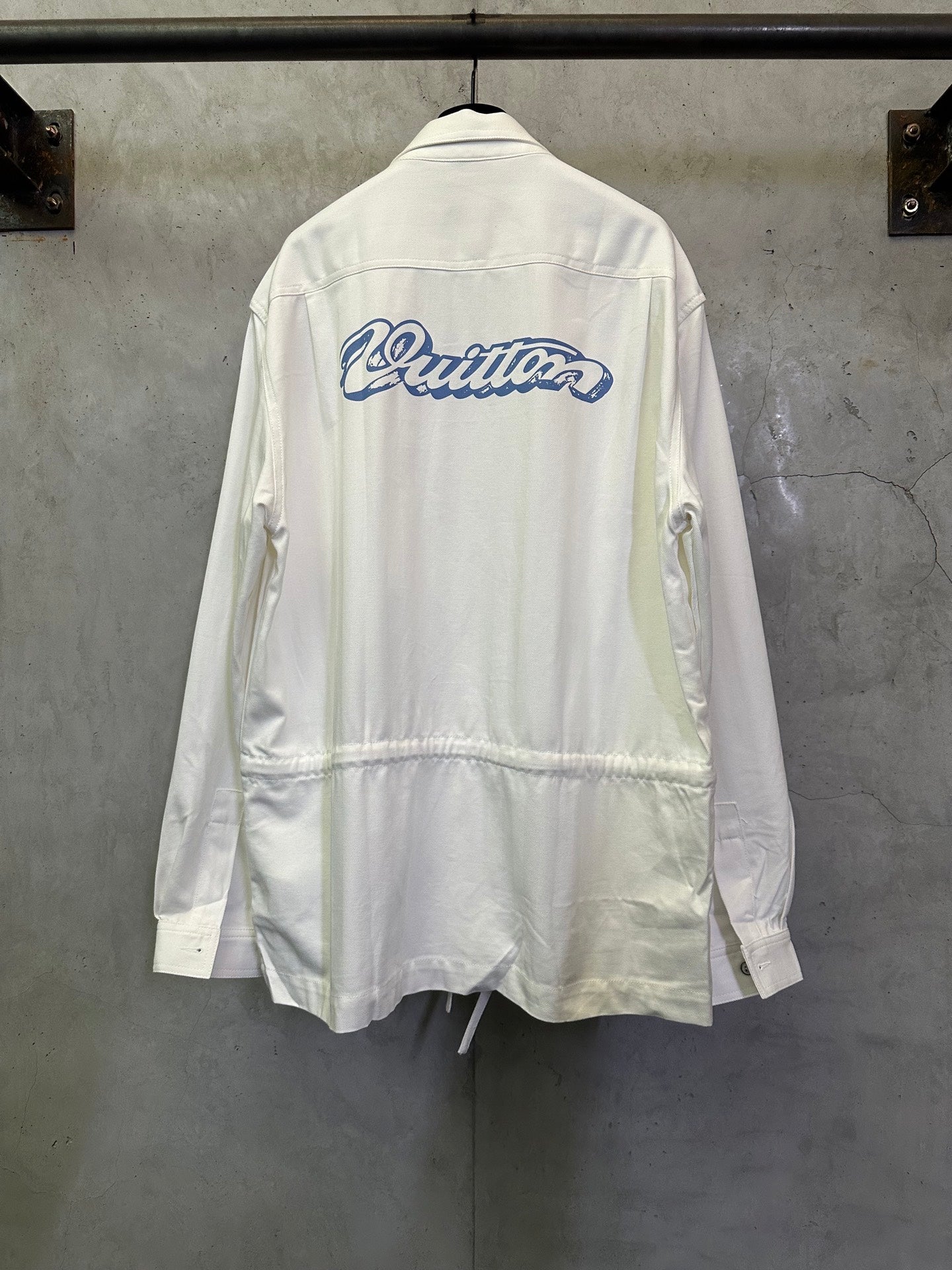 White long-sleeve jacket with back logo and drawstring hem