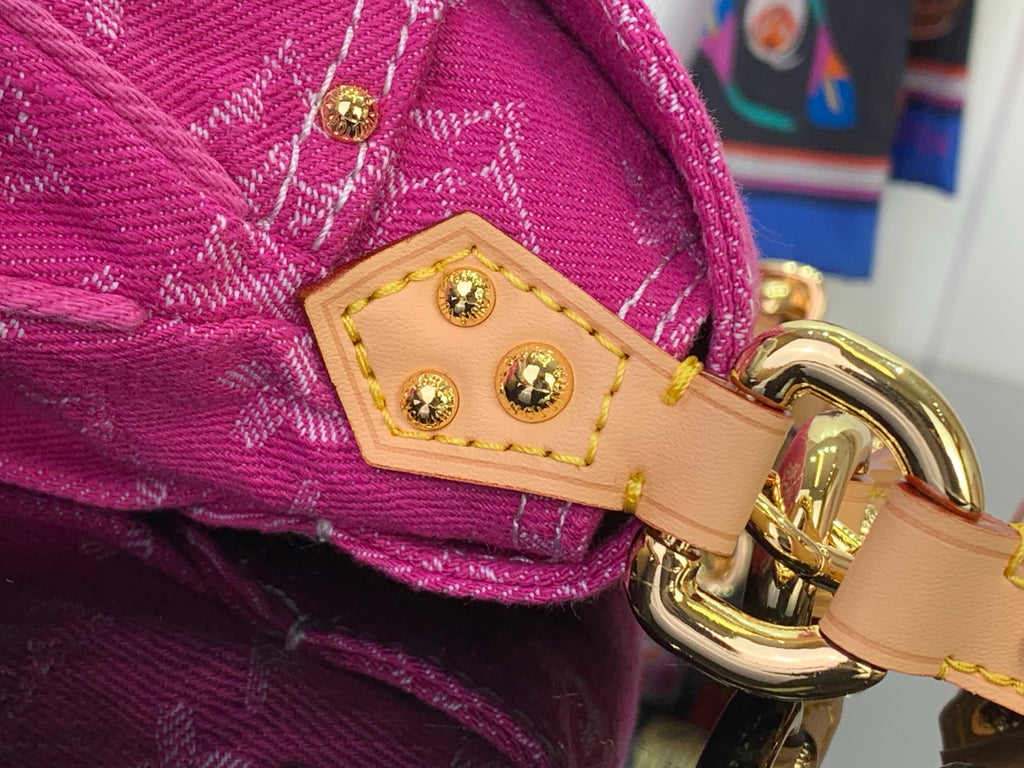 Louis Vuitton handbag strap connector with gold-tone ring and stitched leather patch