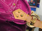 Louis Vuitton handbag strap connector with gold-tone ring and stitched leather patch