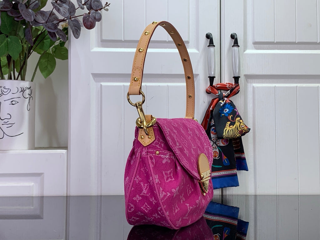 Louis Vuitton monogram handbag in magenta with top handle, long strap, and flap