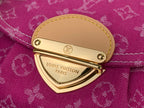 Louis Vuitton handbag logo plate on magenta monogram flap with gold-tone clasp
