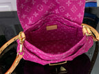 Louis Vuitton monogram handbag in magenta, open top showing inner lining
