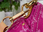 Louis Vuitton handbag close-up with gold-tone clasp and hanging hardware