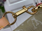 Monogram handbag clasp with gold-tone chain and tan strap