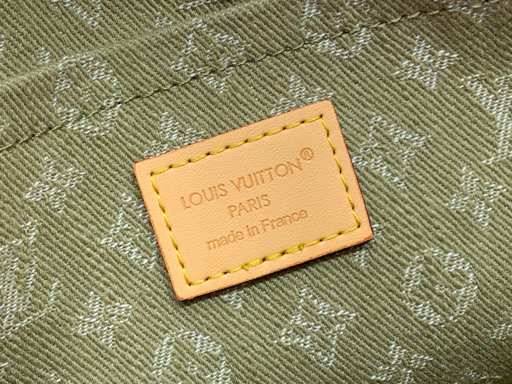 Monogram leather label with printed text on khaki fabric, tan stitching
