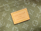 Monogram leather label with printed text on khaki fabric, tan stitching