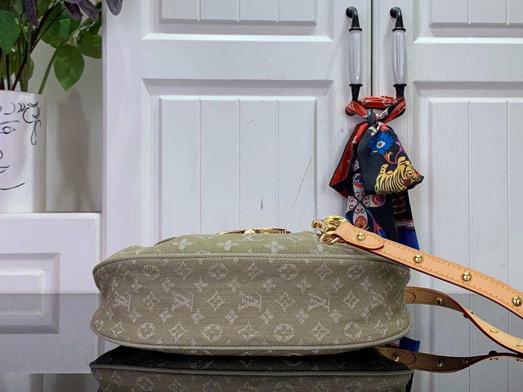 Monogram handbag on stacked base with tan strap and gold hardware