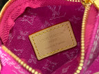 Magenta monogram bag interior label patch on tan leather with gold zipper trim