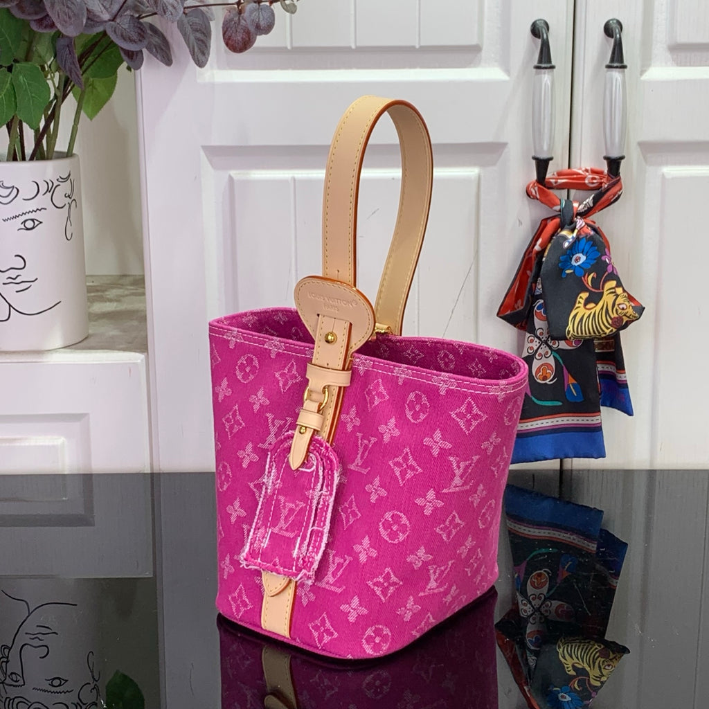 Magenta monogram bucket tote with tan leather handles and front key fob